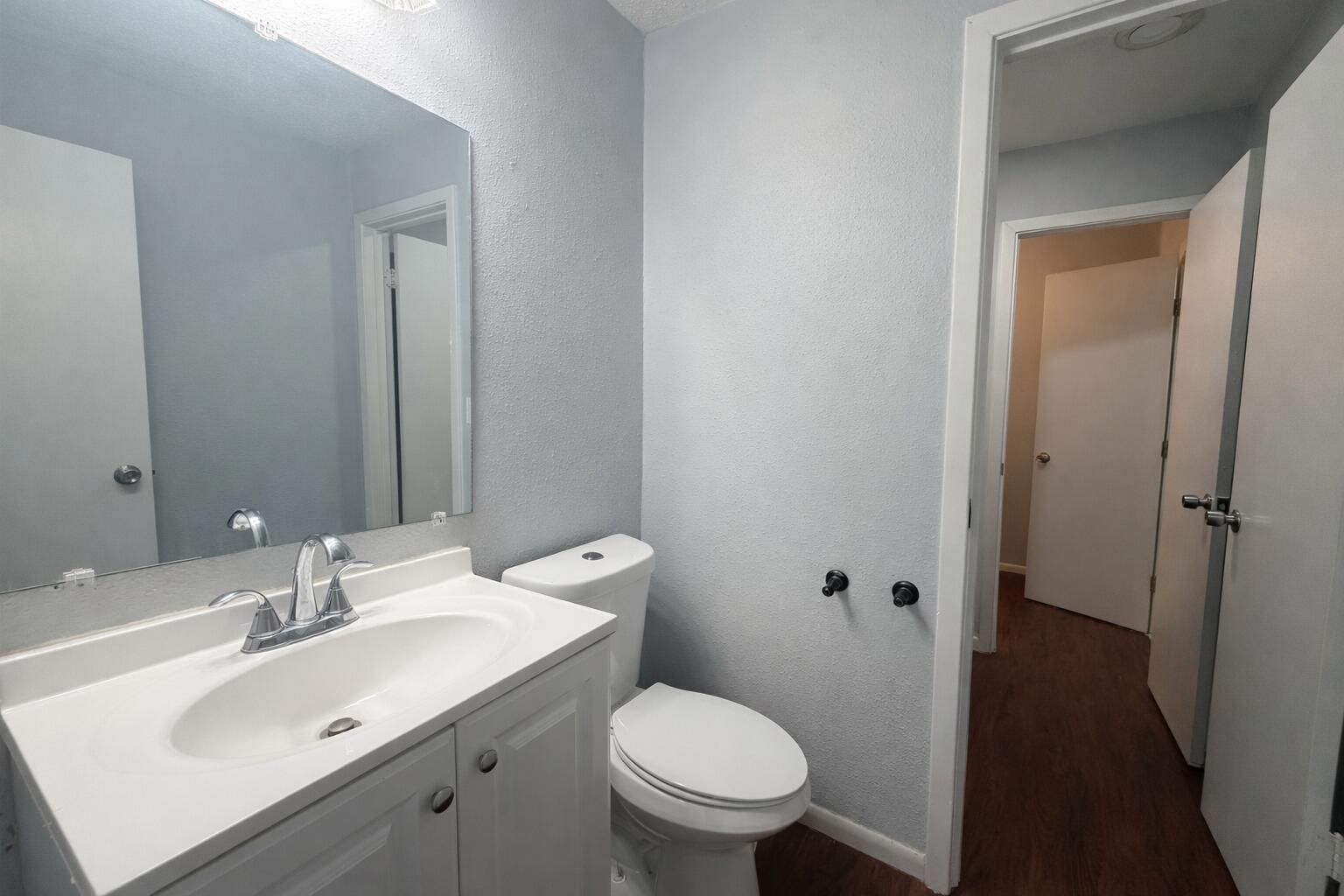 5308 48th Street Lubbock, TX 79414 - Photo 8 of 12 a bathroom with a sink toilet and a mirror