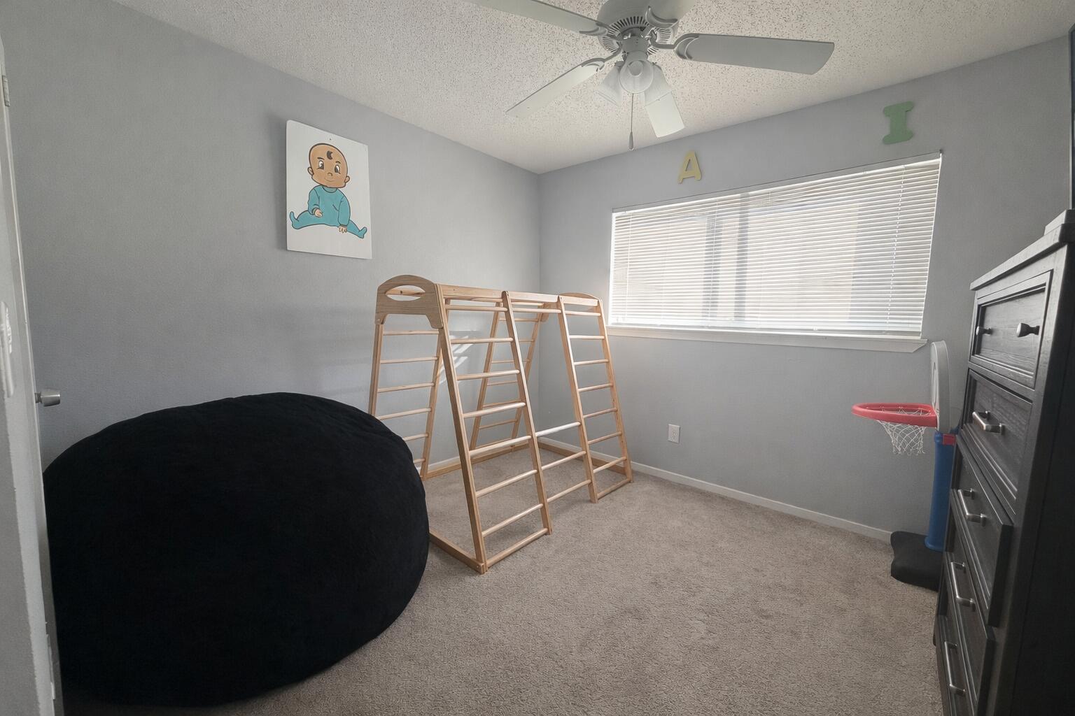 5308 48th Street Lubbock, TX 79414 - Photo 9 of 12 a room with a window and a fan