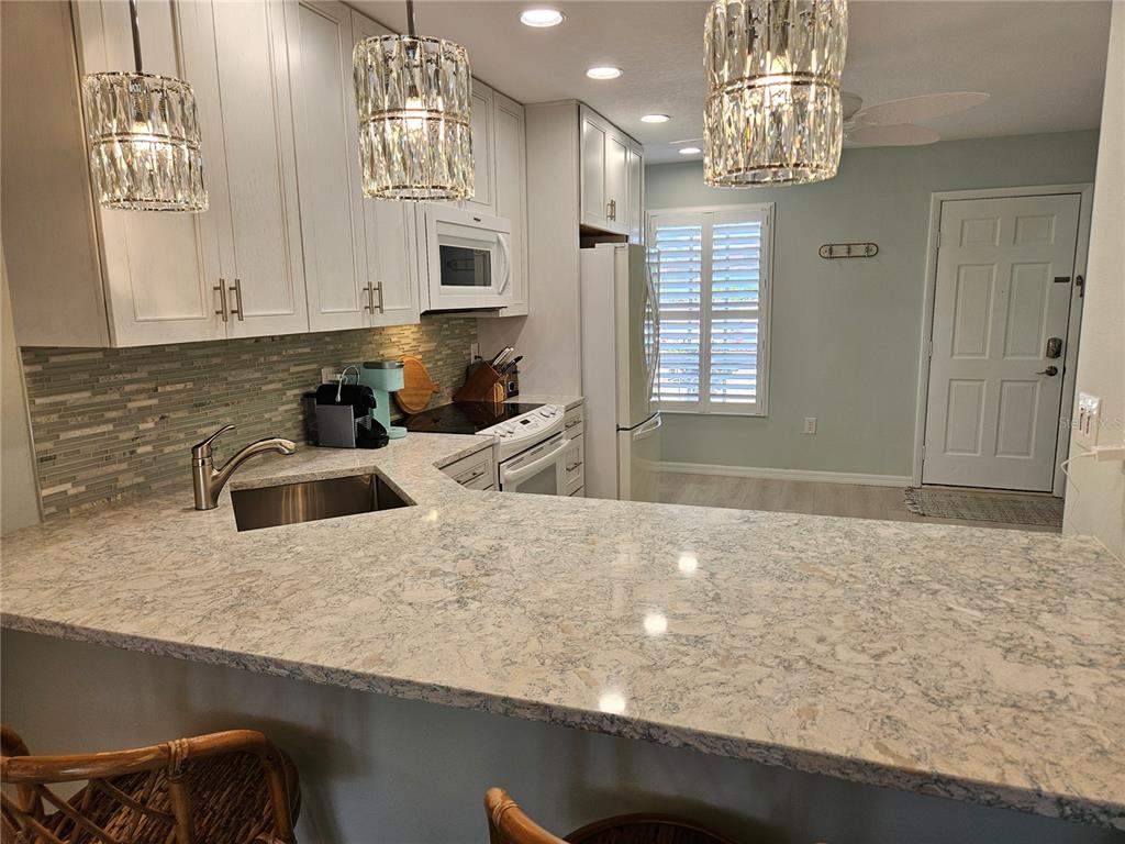 744 Cadiz Road, Unit 1 Venice, FL 34285 - Photo 11 of 46 a kitchen with a sink a counter top space and appliances