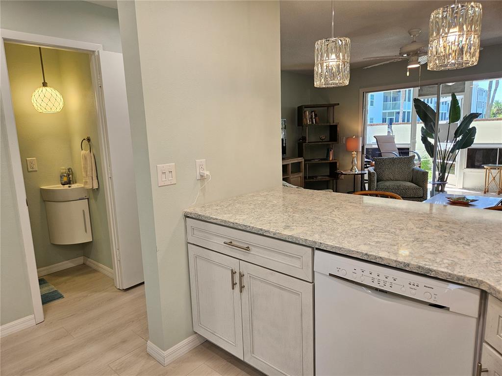 744 Cadiz Road, Unit 1 Venice, FL 34285 - Photo 15 of 46 a bathroom with a granite countertop sink a toilet and a mirror