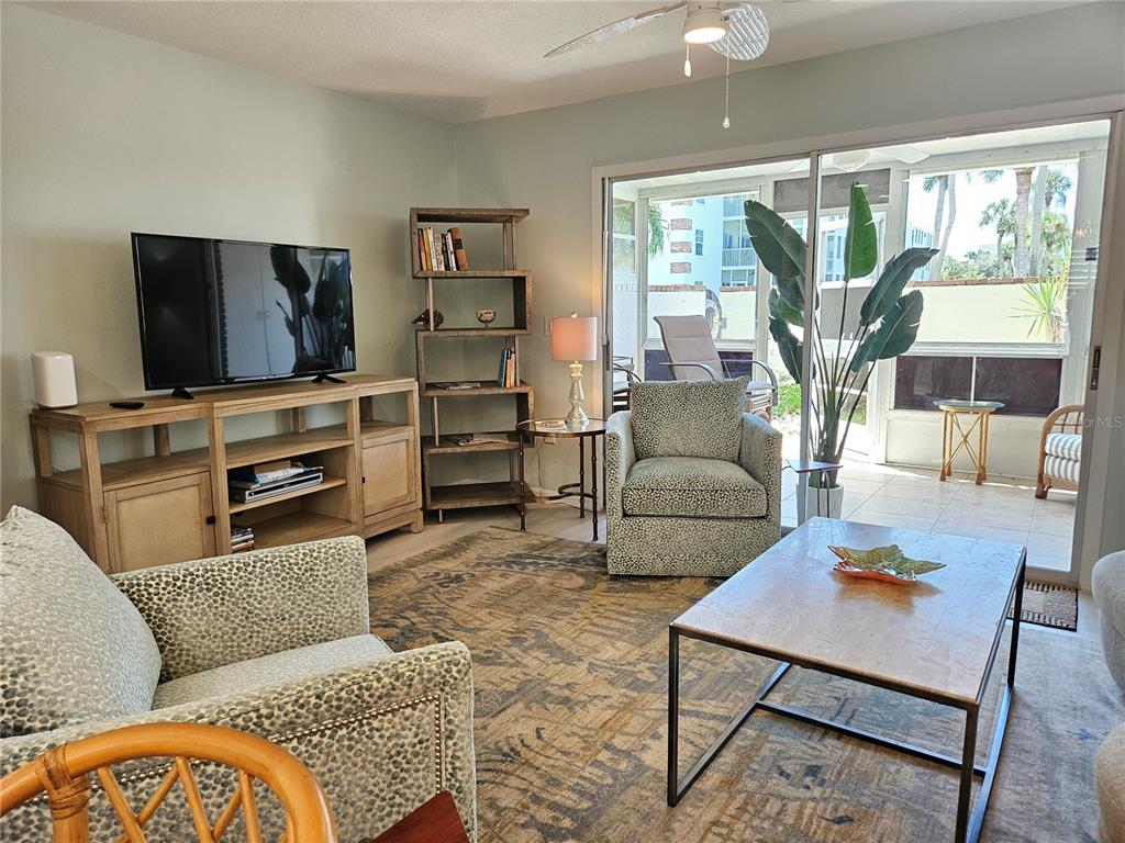 744 Cadiz Road, Unit 1 Venice, FL 34285 - Photo 17 of 46 a living room with furniture and a flat screen tv