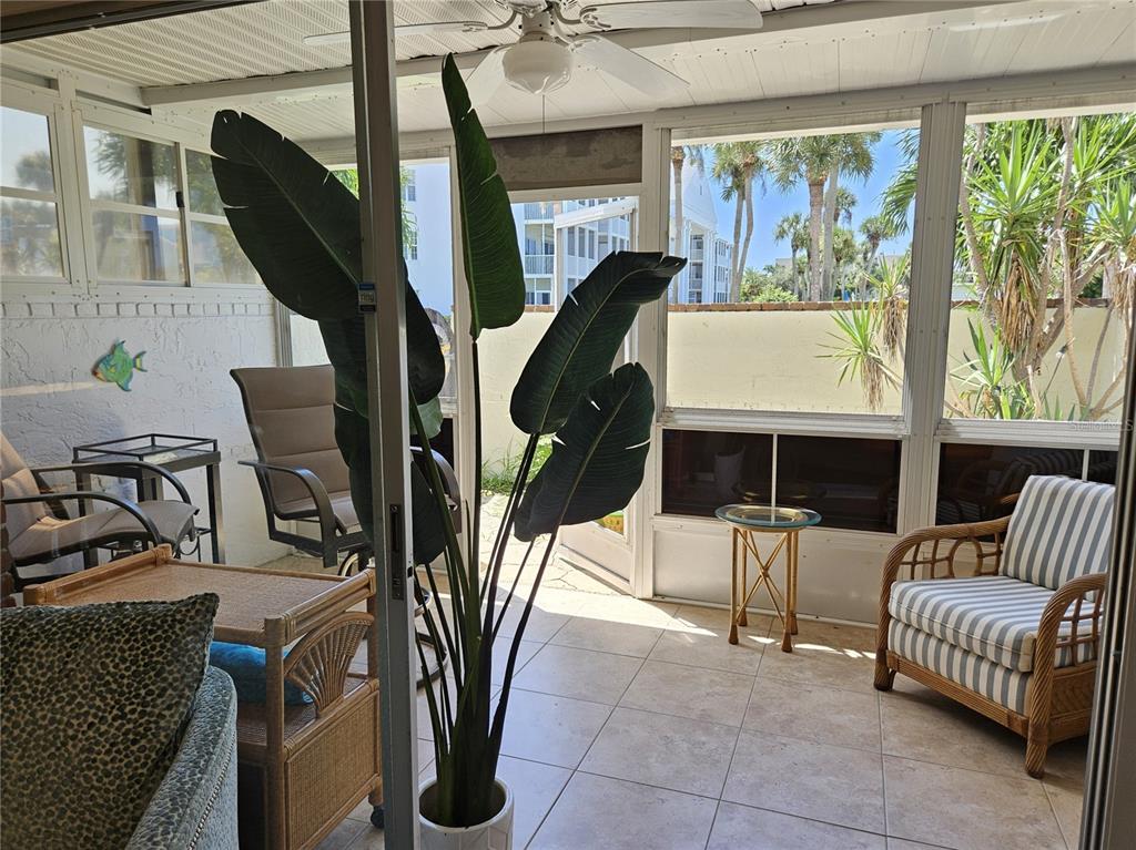 744 Cadiz Road, Unit 1 Venice, FL 34285 - Photo 18 of 46 a living room with furniture a fireplace and blue walls