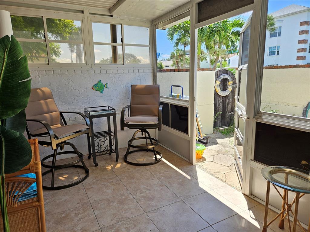 744 Cadiz Road, Unit 1 Venice, FL 34285 - Photo 19 of 46 a view of a chairs and table in a patio