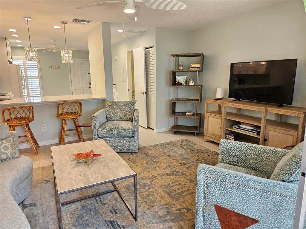 744 Cadiz Road, Unit 1 Venice, FL 34285 - Photo 24 of 46 a living room with furniture and a flat screen tv