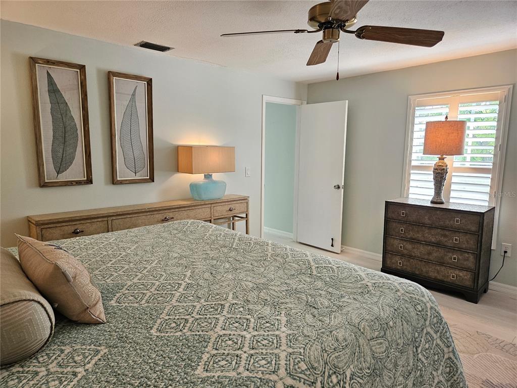 744 Cadiz Road, Unit 1 Venice, FL 34285 - Photo 30 of 46 a bedroom with a bed and dresser