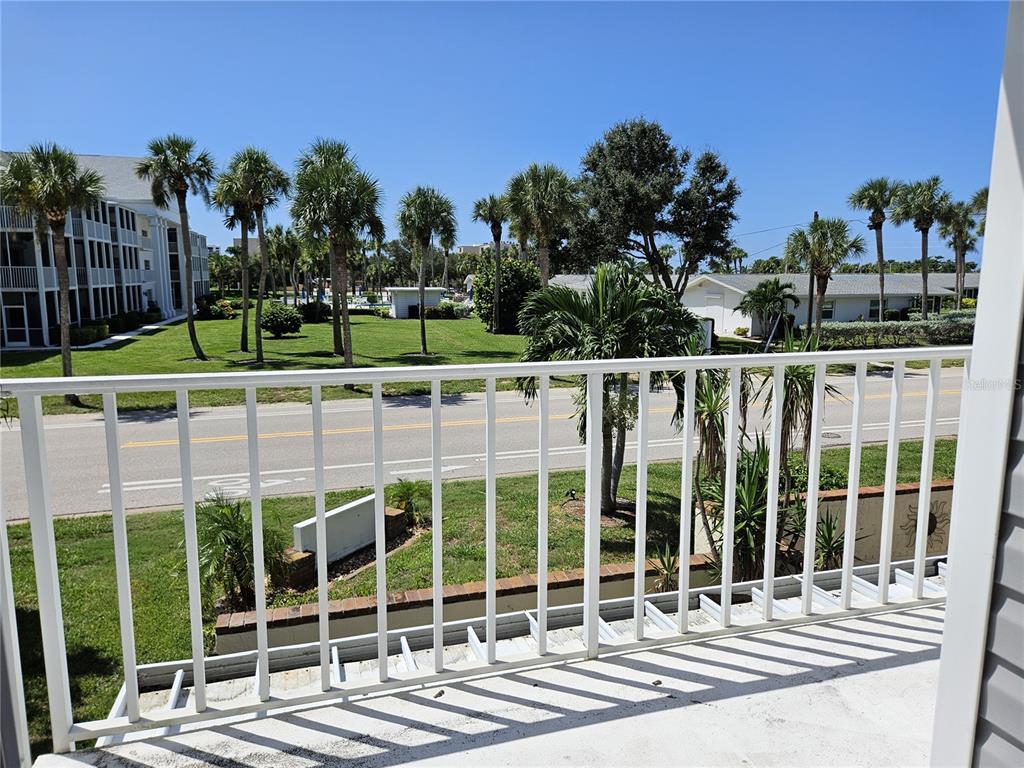 744 Cadiz Road, Unit 1 Venice, FL 34285 - Photo 32 of 46 a view of a balcony and a floor to ceiling window next to a yard