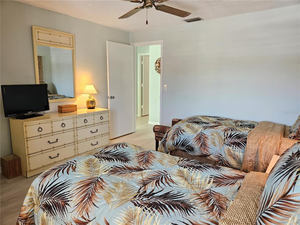 744 Cadiz Road, Unit 1 Venice, FL 34285 - Photo 38 of 46 a bedroom with a bed and a chandelier