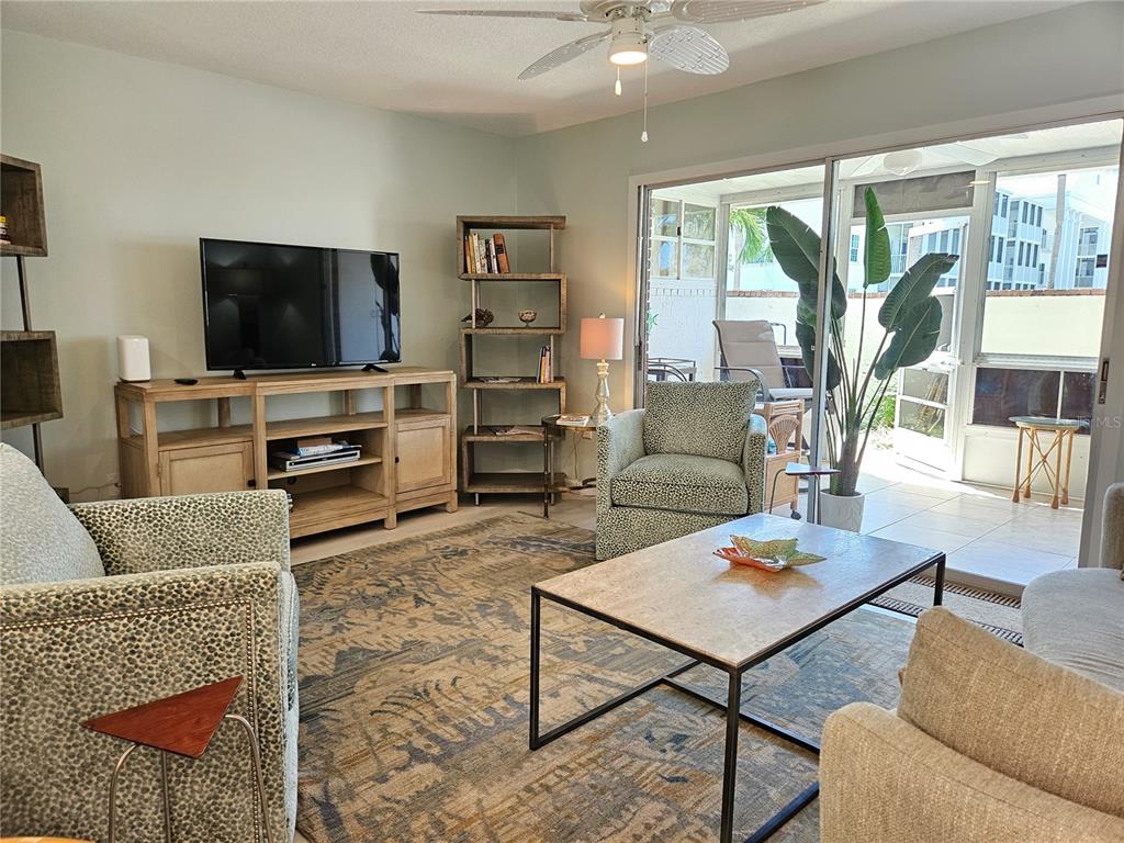744 Cadiz Road, Unit 1 Venice, FL 34285 - Photo 7 of 46 a living room with furniture and a flat screen tv