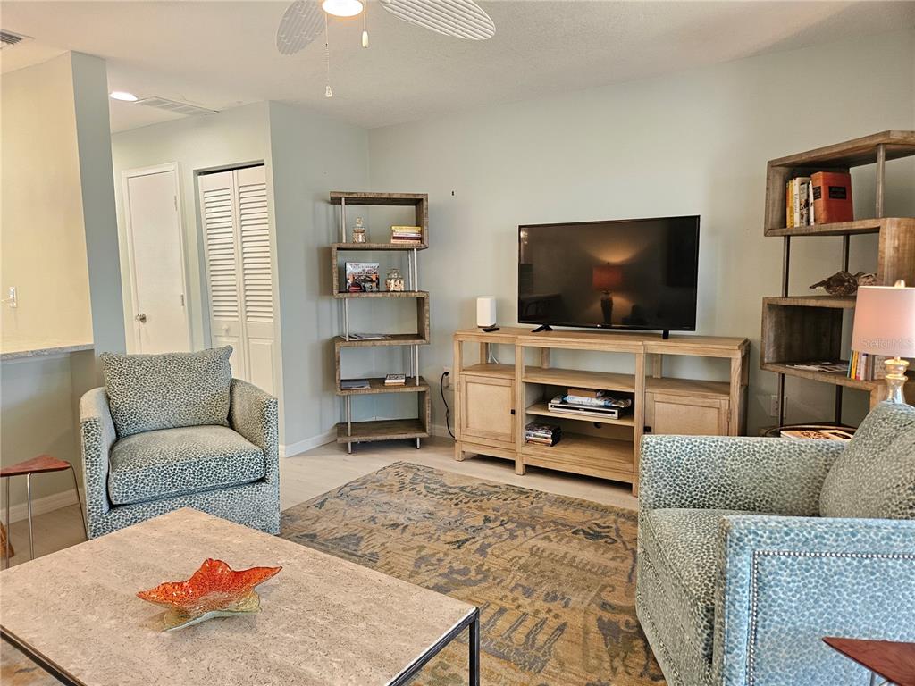 744 Cadiz Road, Unit 1 Venice, FL 34285 - Photo 8 of 46 a living room with furniture and a flat screen tv