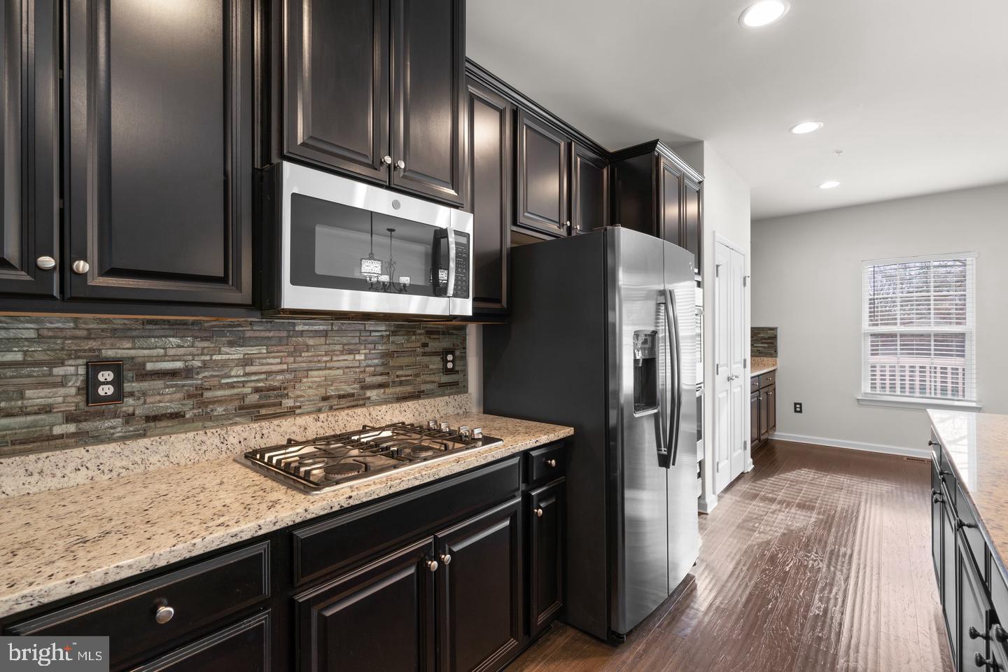 9542 Watts Road Owings Mills, MD 21117 - Photo 12 of 37 Sleek modern kitchen with rich cabinetry.