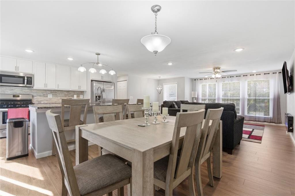 3106 Greenfield Road Glenshaw, PA 15116 - Photo 11 of 47 a view of a dining room and livingroom with furniture wooden floor a rug a chandelier