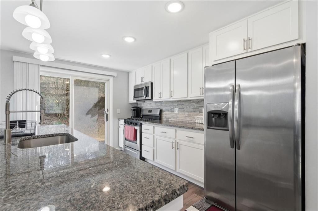 3106 Greenfield Road Glenshaw, PA 15116 - Photo 16 of 47 a kitchen with kitchen island a counter top space cabinets and stainless steel appliances