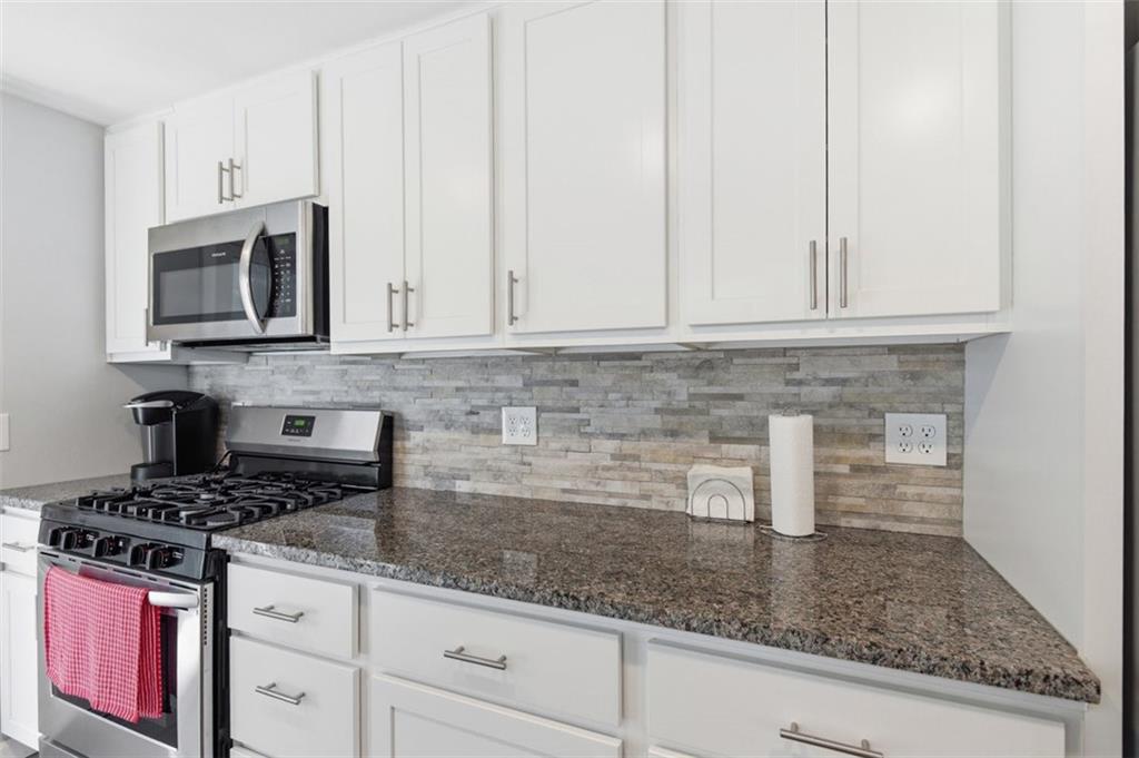 3106 Greenfield Road Glenshaw, PA 15116 - Photo 18 of 47 a kitchen with granite countertop white cabinets stainless steel appliances and a counter space