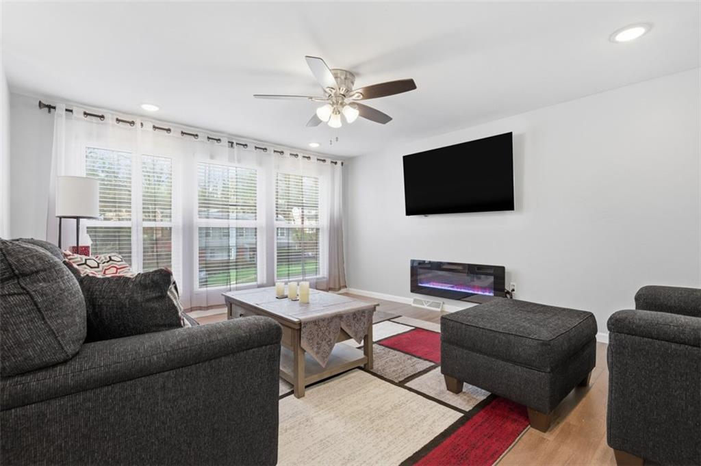 3106 Greenfield Road Glenshaw, PA 15116 - Photo 7 of 47 a living room with furniture a flat screen tv and a large window