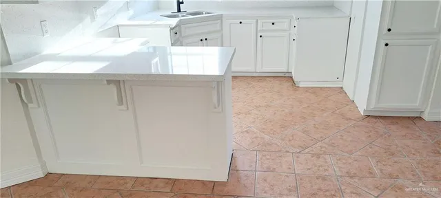 a utility room with cabinets washer and dryer