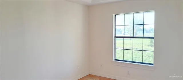 a picture of a room with a window and a ceiling fan