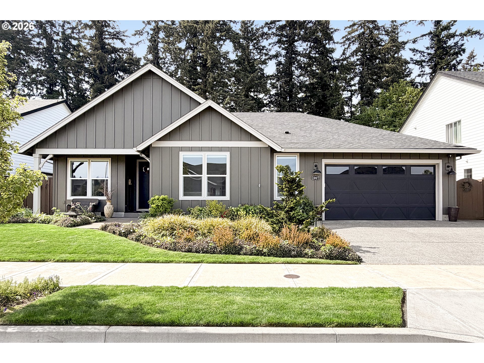 1927 South Fir Loop Canby, OR 97013 - Photo 1 of 35 a front view of a house with a yard and garage