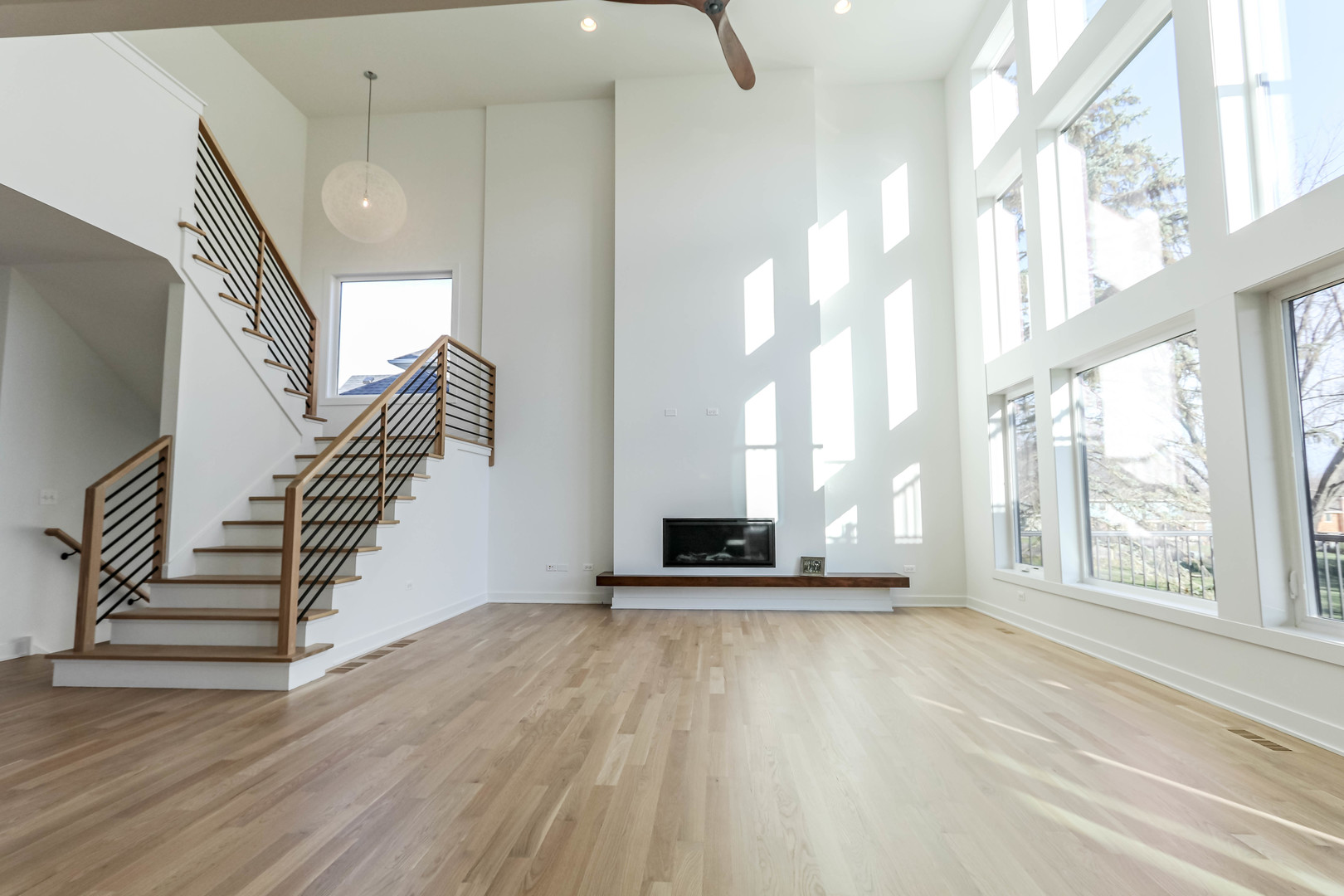 27-w151 48th Street Naperville, IL 60563 - Photo 12 of 25 a view of an empty room with wooden floor and a window