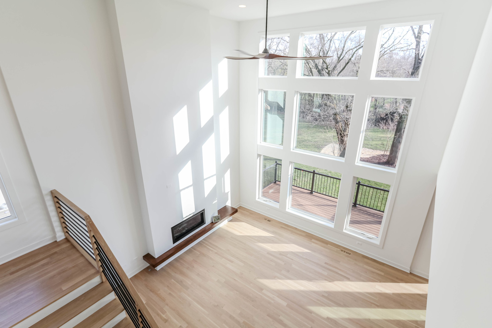27-w151 48th Street Naperville, IL 60563 - Photo 14 of 25 a view of an empty room with wooden floor and a window