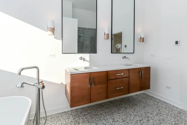 a spacious bathroom with a sink and a mirror