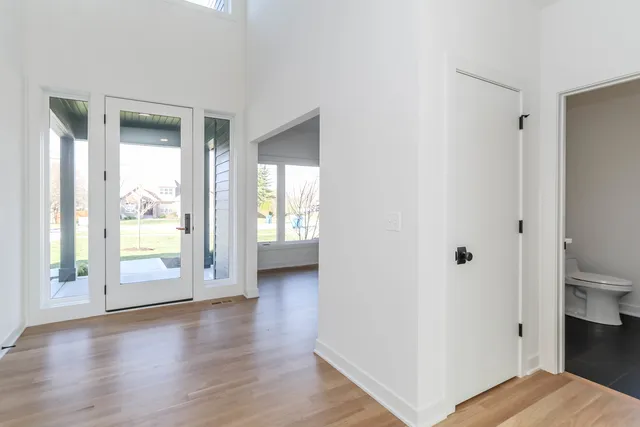 a view of a bedroom with wooden floor and window