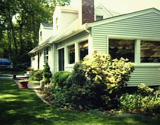 18 Samuelson Road Weston, CT 06883 - Photo 1 of 1 a front view of a house with a yard and potted plants