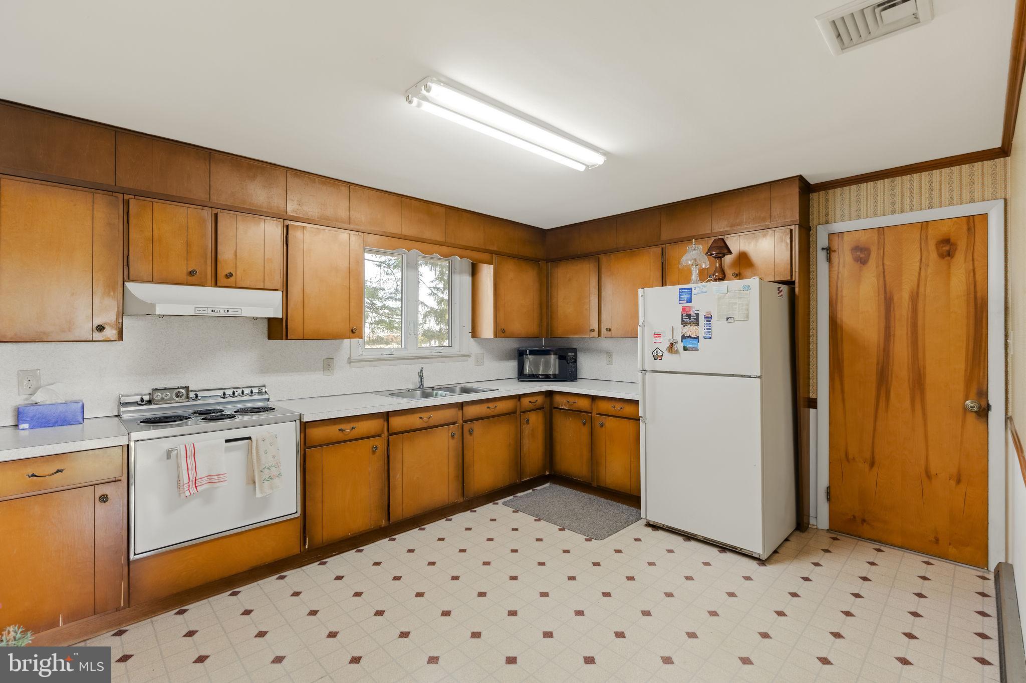 337 Long Road Manheim, PA 17545 - Photo 8 of 50 a kitchen with a sink a refrigerator and cabinets