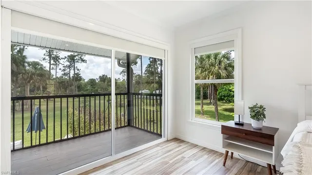 a view of a room with wooden floor and a balcony