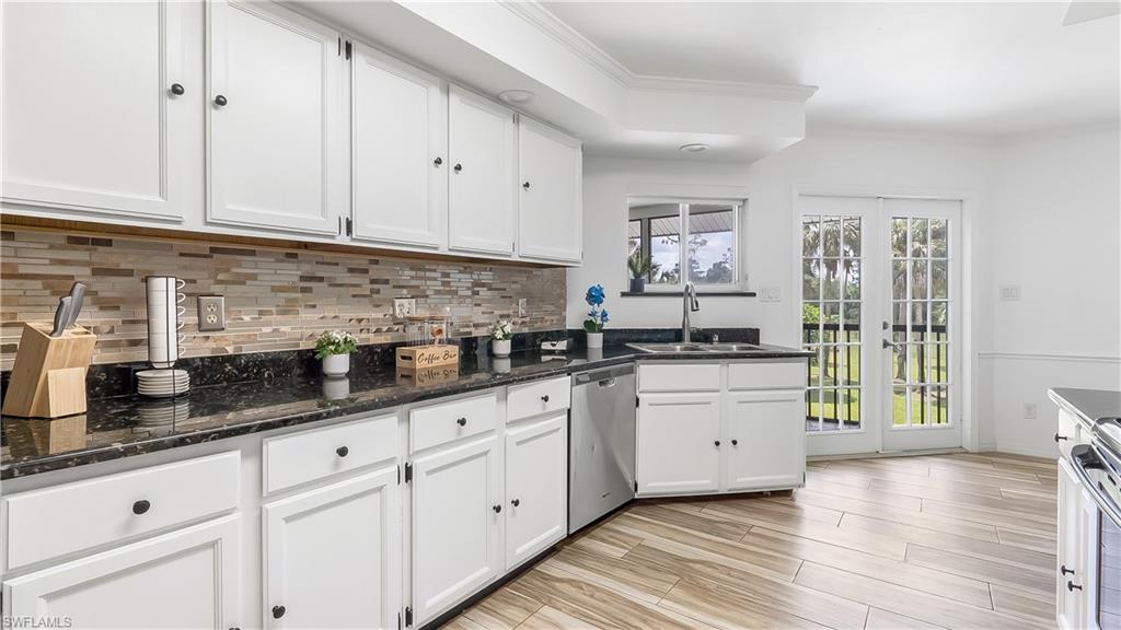 2920 24th Avenue Southeast Naples, FL 34117 - Photo 13 of 50 a kitchen with granite countertop white cabinets and white appliances