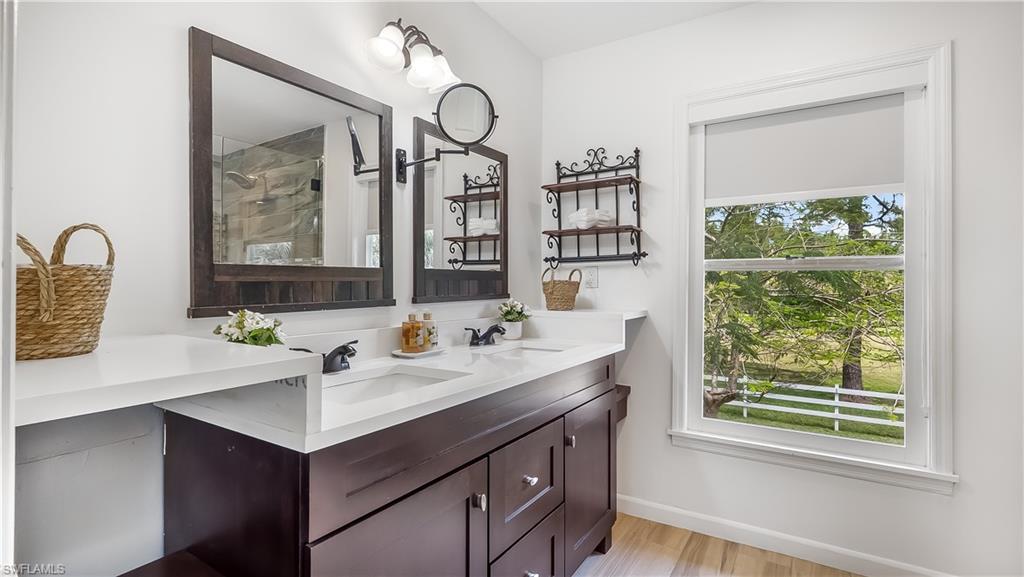 2920 24th Avenue Southeast Naples, FL 34117 - Photo 22 of 50 a bathroom with a sink and a mirror