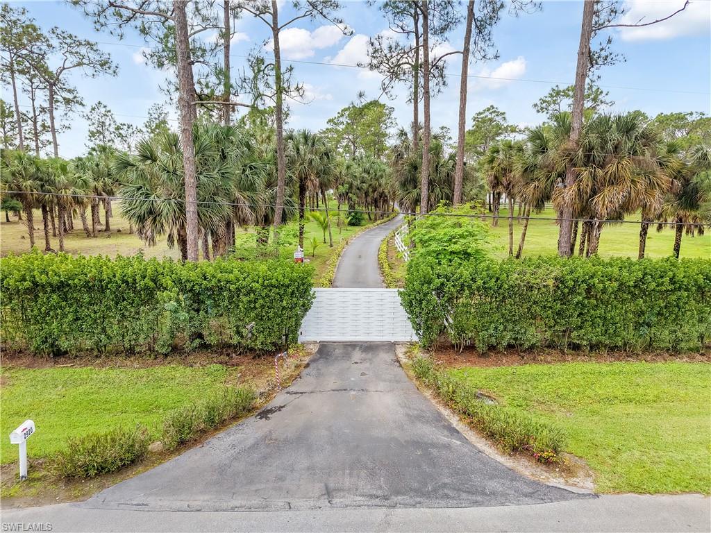 2920 24th Avenue Southeast Naples, FL 34117 - Photo 33 of 50 a view of a pathway with a yard