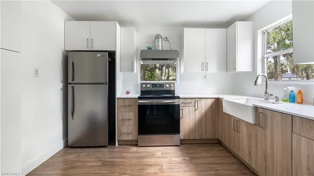 a kitchen with a refrigerator and a sink