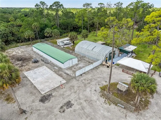 an aerial view of a house with a yard and lake view