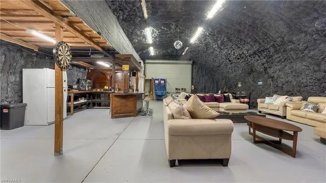 a living room with furniture and kitchen view