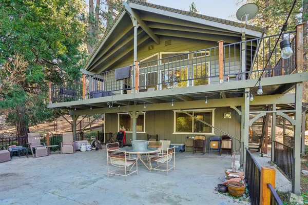 a view of a house with a patio and a yard