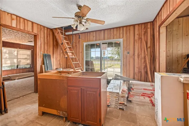 a dining table chair next to a window