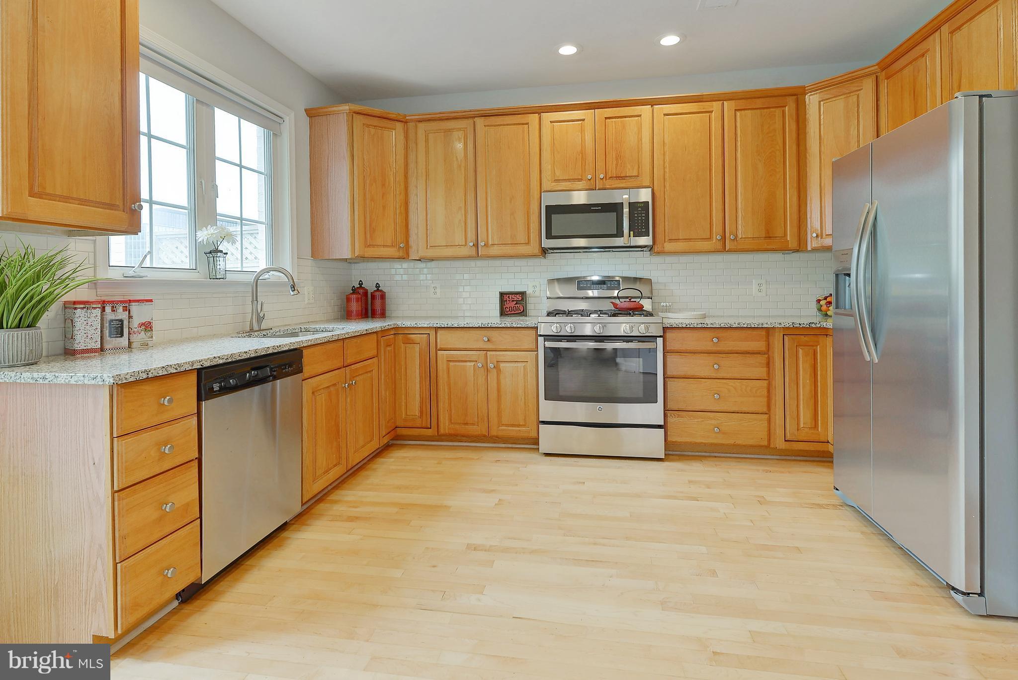 807 Capitol Square Place Southwest Washington, DC 20024 - Photo 10 of 30 a kitchen with stainless steel appliances granite countertop a stove a sink dishwasher and a refrigerator