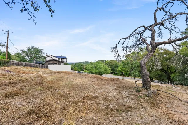 a backyard of a house with large trees