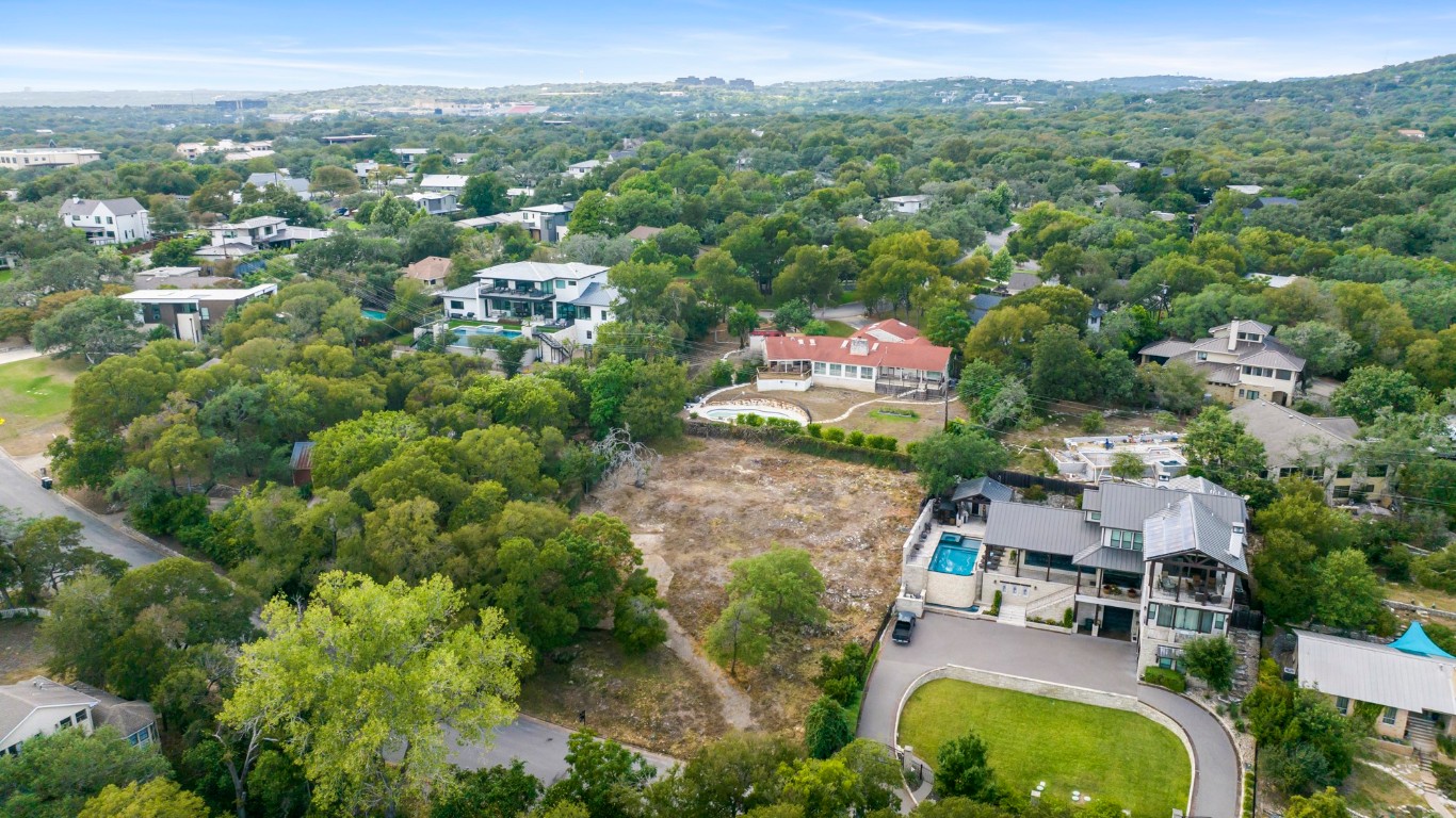 Undisclosed Address Austin, TX 78746 - Photo 2 of 15 an aerial view of residential houses with outdoor space and trees