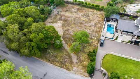 an aerial view of a house with a yard basket ball court and outdoor seating