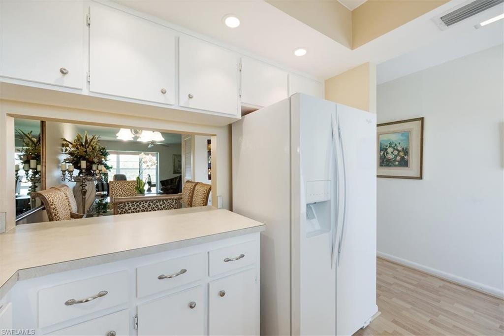 315 St Andrews Boulevard, Unit D37 Naples, FL 34113 - Photo 12 of 31 a view of a hallway with cabinet and mirror