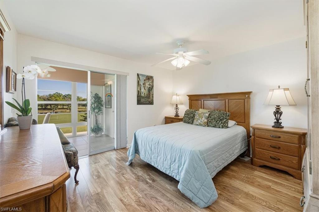 315 St Andrews Boulevard, Unit D37 Naples, FL 34113 - Photo 14 of 31 a bedroom with a large bed and a large window