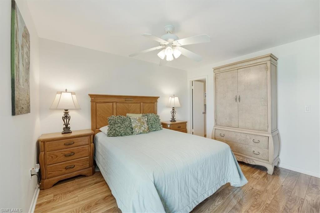 315 St Andrews Boulevard, Unit D37 Naples, FL 34113 - Photo 15 of 31 a bedroom with a bed and a lamp