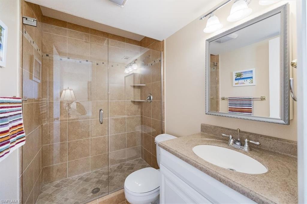315 St Andrews Boulevard, Unit D37 Naples, FL 34113 - Photo 17 of 31 a bathroom with a sink a toilet and shower