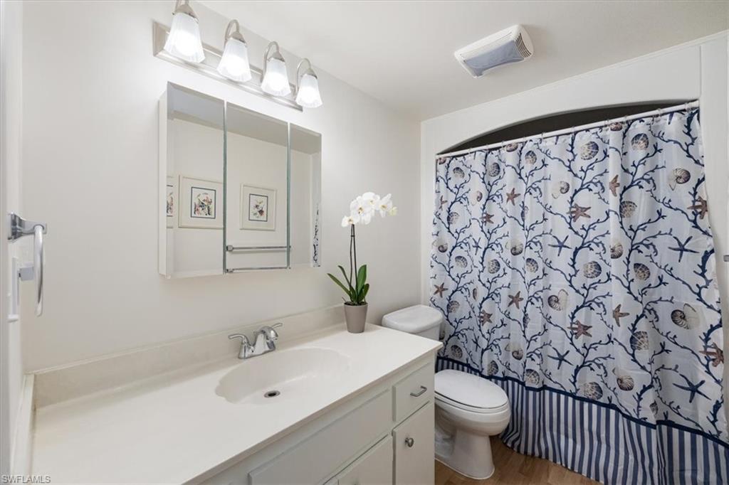 315 St Andrews Boulevard, Unit D37 Naples, FL 34113 - Photo 20 of 31 a bathroom with a sink and mirror with toilet