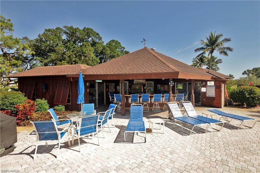315 St Andrews Boulevard, Unit D37 Naples, FL 34113 - Photo 24 of 31 a view of a house with backyard sitting area and swimming pool