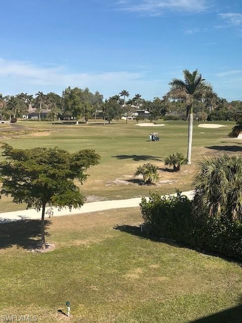 315 St Andrews Boulevard, Unit D37 Naples, FL 34113 - Photo 26 of 31 a view of a lake with a yard