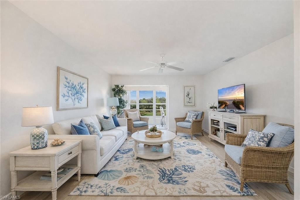 315 St Andrews Boulevard, Unit D37 Naples, FL 34113 - Photo 3 of 31 a living room with furniture and a flat screen tv