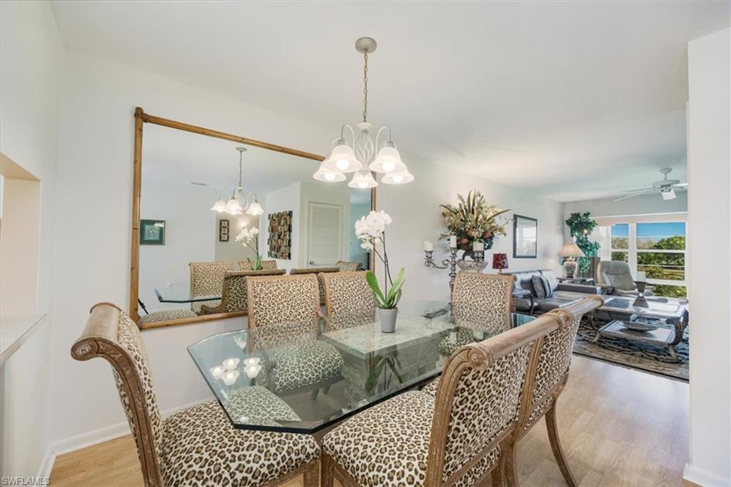 315 St Andrews Boulevard, Unit D37 Naples, FL 34113 - Photo 4 of 31 a living room with furniture a chandelier and a rug