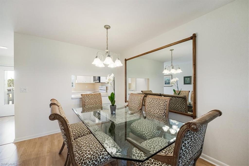315 St Andrews Boulevard, Unit D37 Naples, FL 34113 - Photo 10 of 31 a view of a dining room with furniture